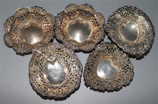 A pair of Edwardian pierced silver bonbon dishes and three other silver dishes,